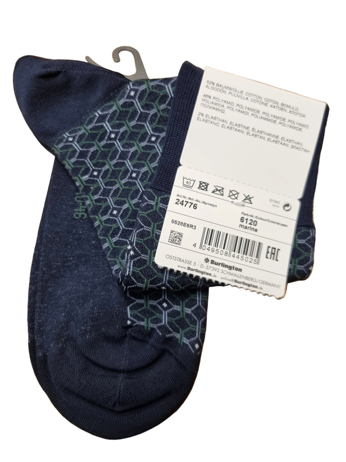 A pair of dark navy blue crew socks with a green and gray geometric pattern on the sides,
