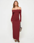 Front view of a model wearing the LSPACE Carrie Dress in sangria, featuring an off-the-shoulder neckline with a folded band, long sleeves, and a body-hugging maxi silhouette in ribbed sangria knit fabric, styled with a zebra print clutch.