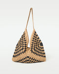 Off-model side view of the natural black Coastline Beach Bag showing its single shoulder strap.
