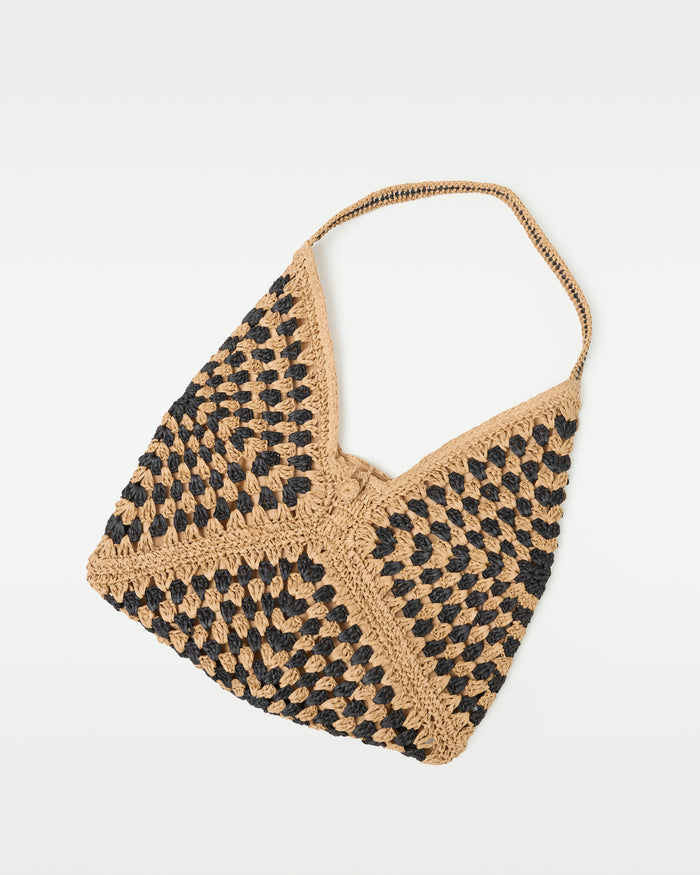 Flat lay of the natural black Coastline Beach Bag showing the open-top crochet tote construction.
