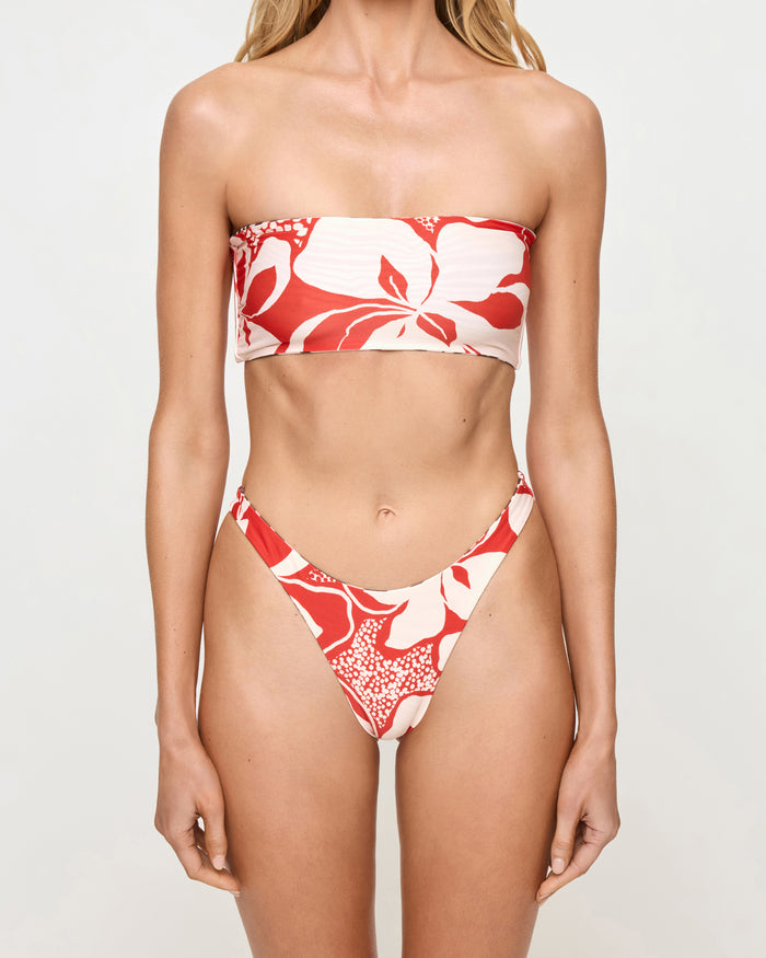 Close-up front view of a model wearing the LSPACE Animal Hibiscus Bloom Damian Bikini Bottom with the hibiscus bloom print side facing out and matching bandeau Avalon Bikini Top.