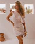 Lifestyle image of model wearing the LSPACE Frankie Mini in tapioca, a short mini dress.