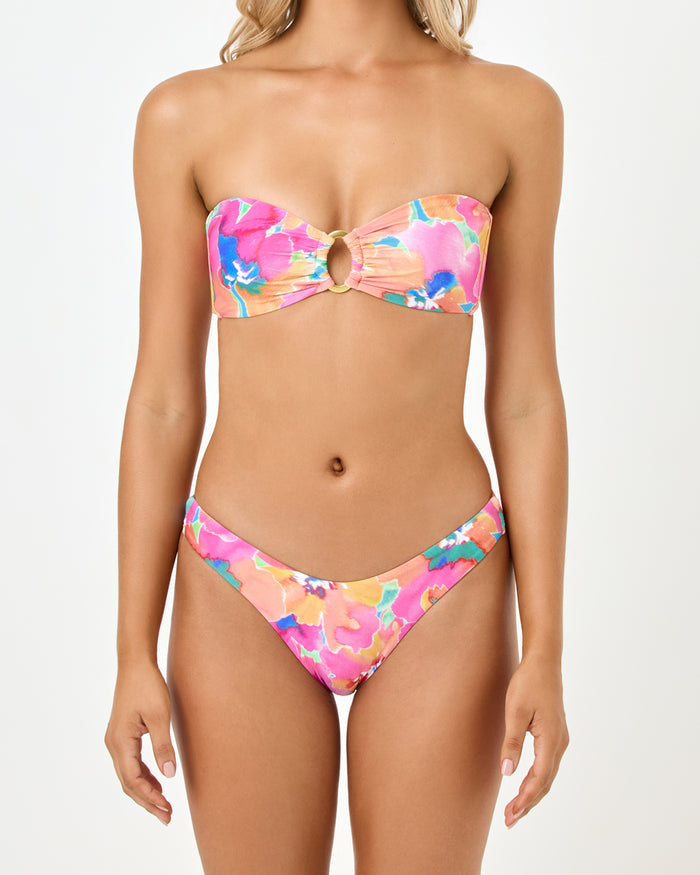 Close-up front view of a model wearing the LSPACE Flower Play Jasper Bikini Top highlighting the center ring cutout of the strapless bandeau style.