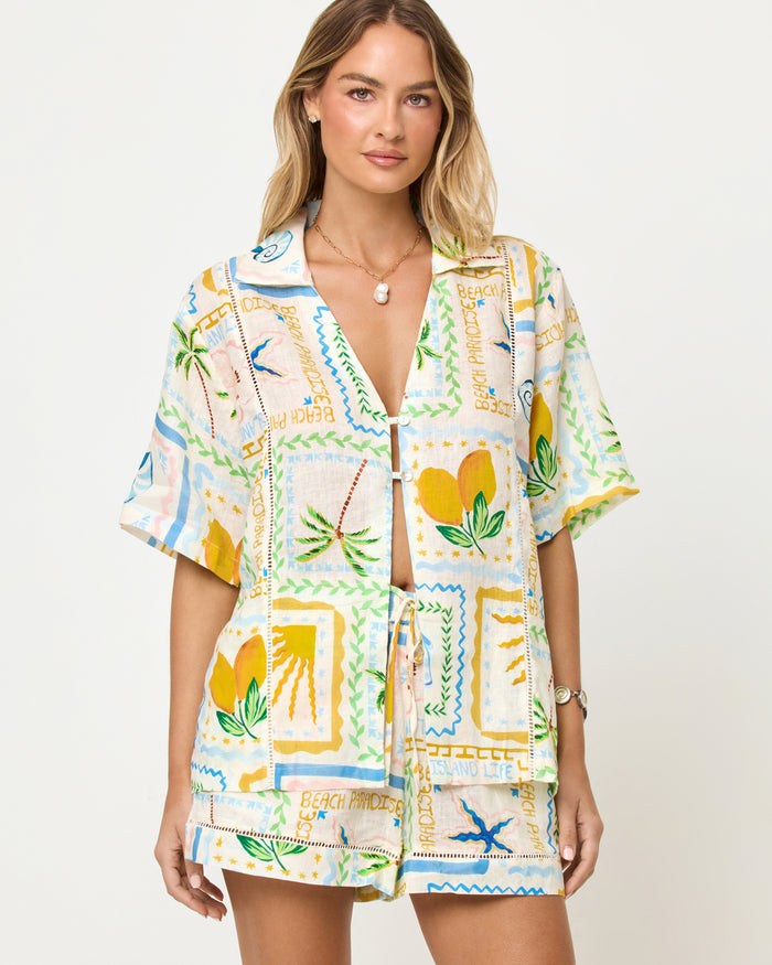 LSPACE La Mer Short and Shirt in Wish You Were Here print, zoomed in front view on model styled with matching shorts.