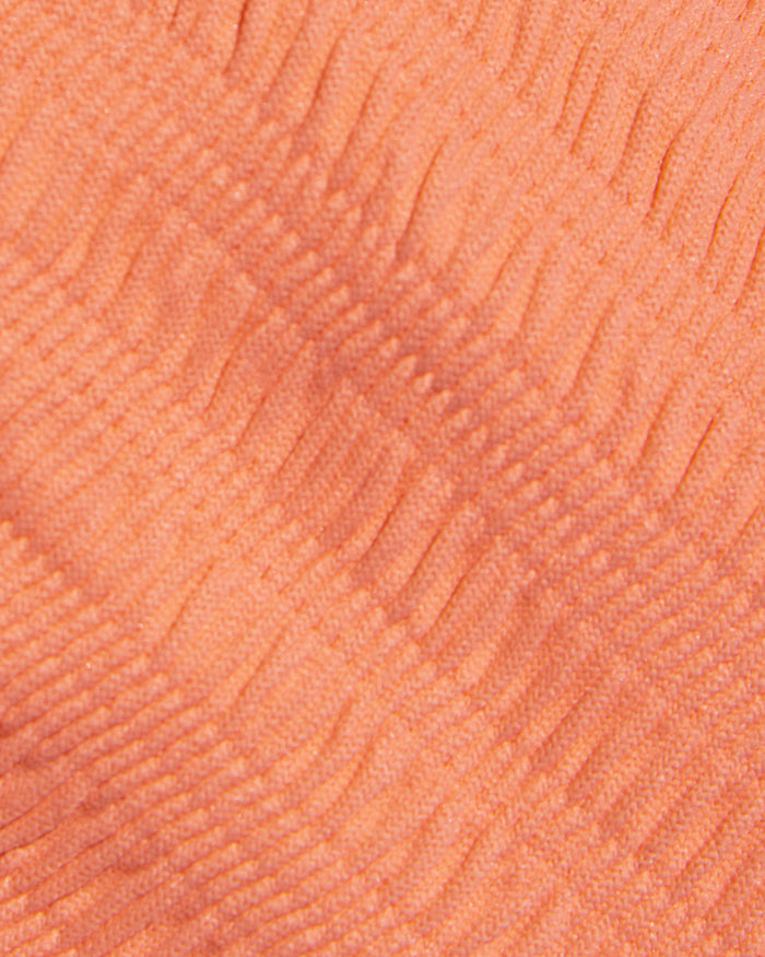 Close-up detail of the Fresh Squeezed fabric texture of the LSPACE Leilani Bikini Bottom, showing the peach-orange ribbed swimwear material.