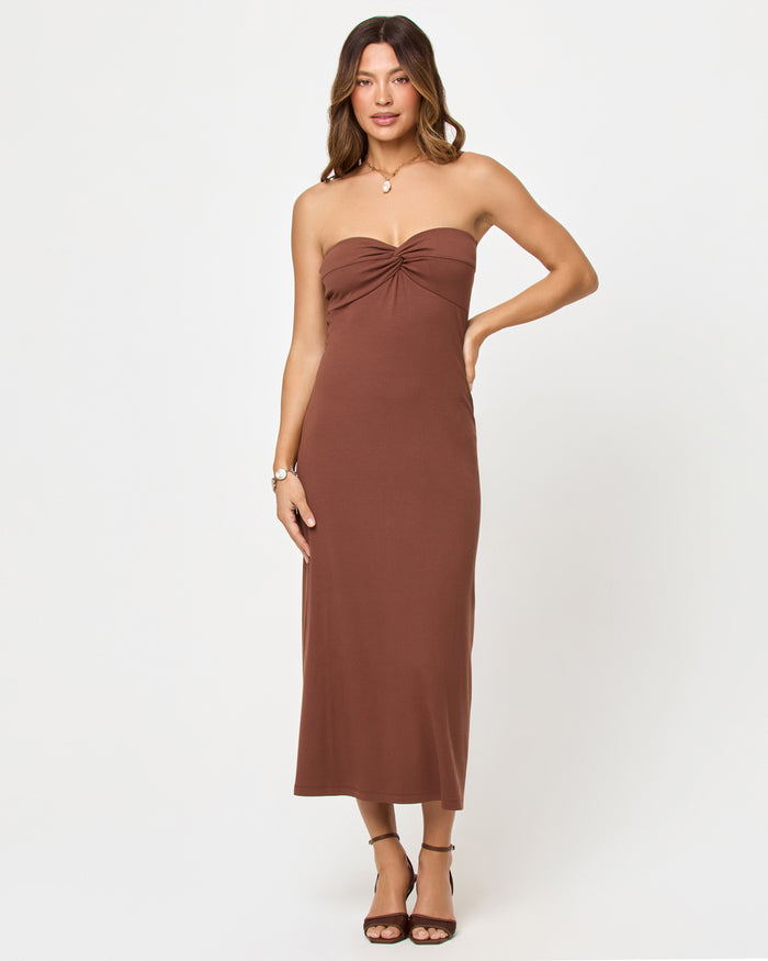 Front view of model wearing the LSPACE Lisette Dress in cafe, a mini dress with a V-neckline and short sleeves.