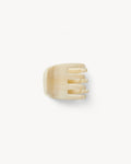 Off-model top-down view of the Machete Mini Claw in alabaster showing the teeth and solid cream acetate.
