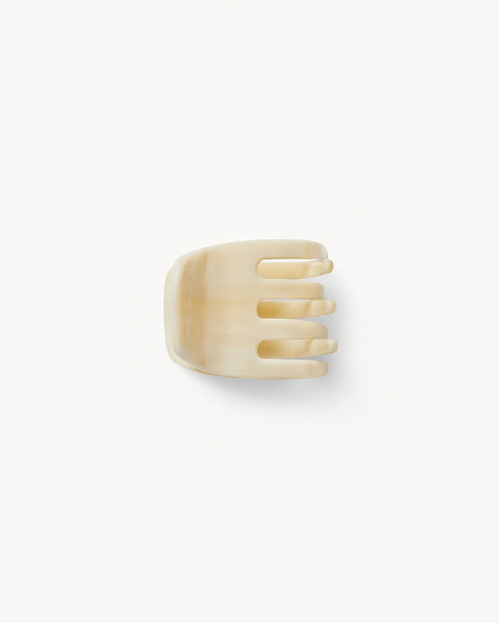 Off-model top-down view of the Machete Mini Claw in alabaster showing the teeth and solid cream acetate.