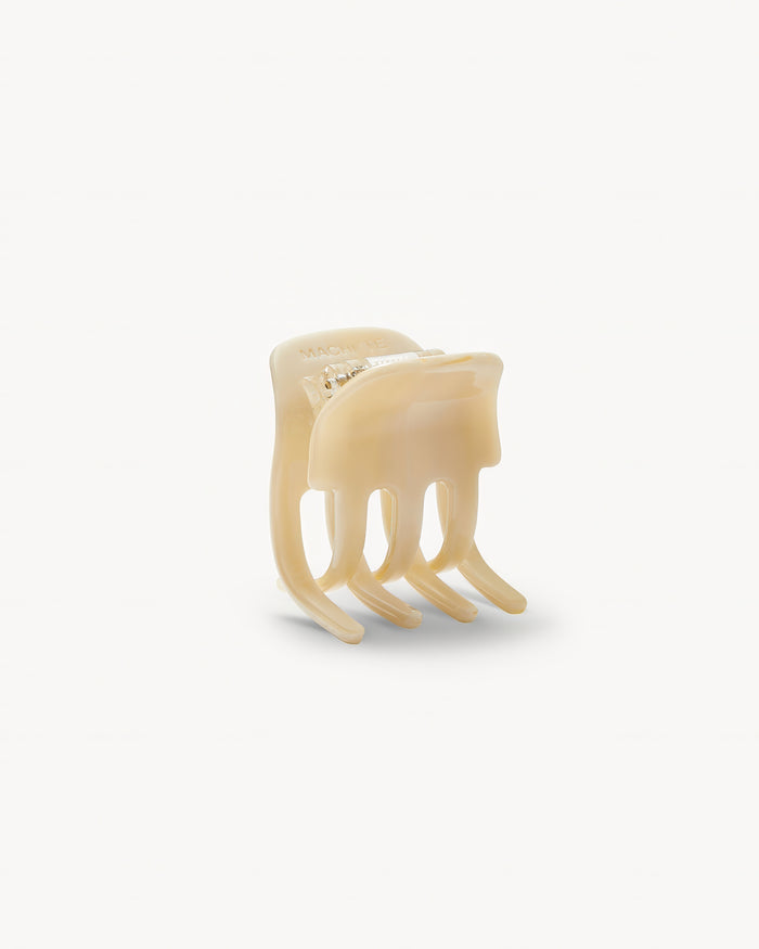 Off-model open detail view of the Machete Mini Claw in alabaster showing the teeth and cream acetate construction.