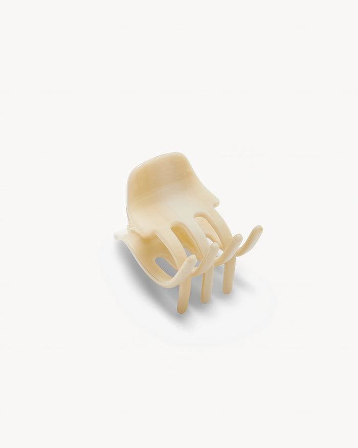 Off-model angled top-down view of the Machete Mini Claw in alabaster showing the front of the claw.