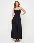 Front view of a model wearing the LSPACE Misha Midi in black, featuring thin spaghetti straps, a scoop neckline, a smocked fitted bodice, and a full flowing black skirt.