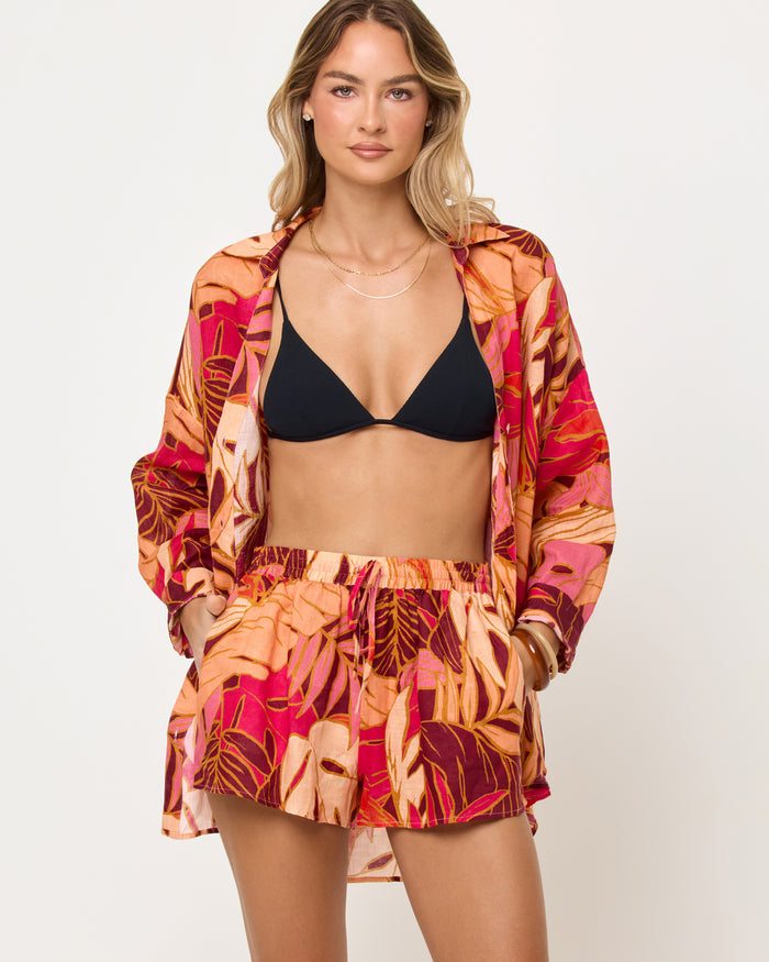 Close-up front view of model wearing the LSPACE Rio Short in leaf it to me showing the waistband and leaf print detail.