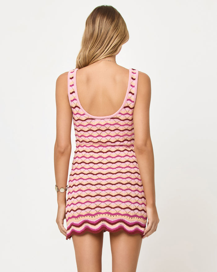 Back view of model wearing the LSPACE Sunchaser Dress in berry spritz, a crochet mini dress.
