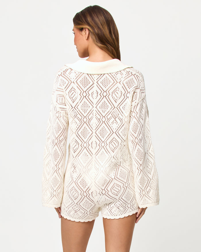 Back view of model wearing the LSPACE x The Salty Blonde Golden Daze Romper in cream.