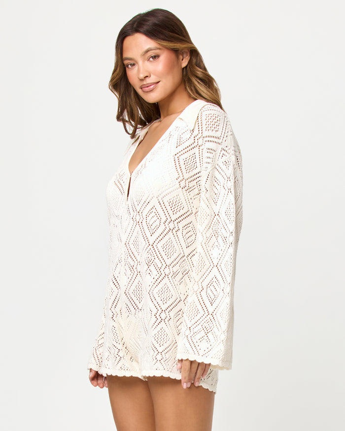 Side view of model wearing the LSPACE x The Salty Blonde Golden Daze Romper in cream.